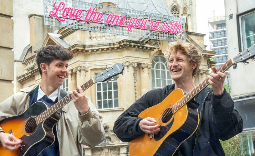 Buskers in front of 'Love the one you're with' installation on Corn Street